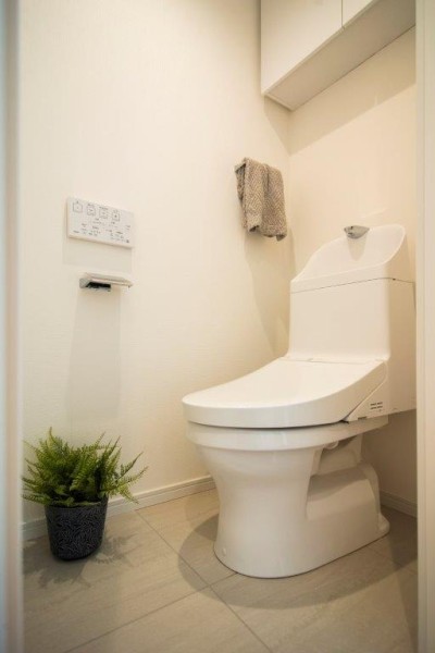 TOTO製ウォシュレット一体型のトイレは、お掃除の手助けをしてくれる便利機能が搭載されています。吊戸棚も設置しましたので、収納も便利です。