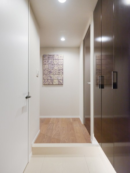 フットライトが足元を照らし、大きなシューズボックスにはたっぷりと収納可能です。ピクチャーレールがあるので、お気に入りの絵やインテリアを飾ってお客様をお出迎えできる玄関です。