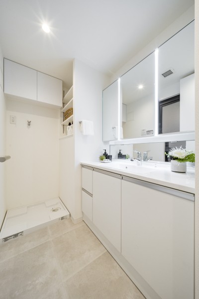 身支度の時間をも快適に彩る、美しく空間に溶け込む洗面化粧台です。洗濯機置場の上には便利な吊戸棚を備え付けました。